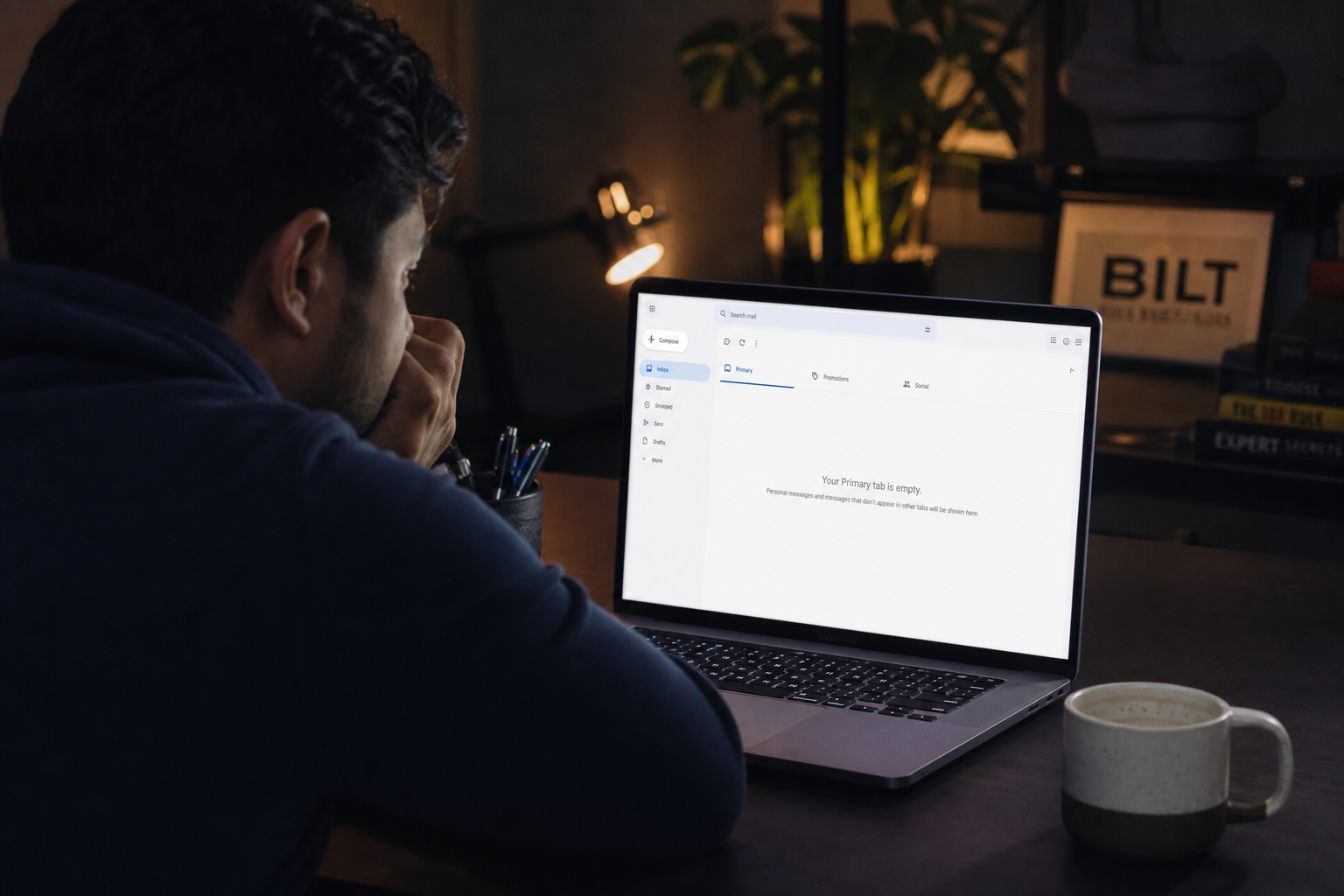 photorealistic scene of a person staring at a laptop showing an empty email inbox, dim room lighting, coffee cup half full, subtle sense of frustration, realistic home office