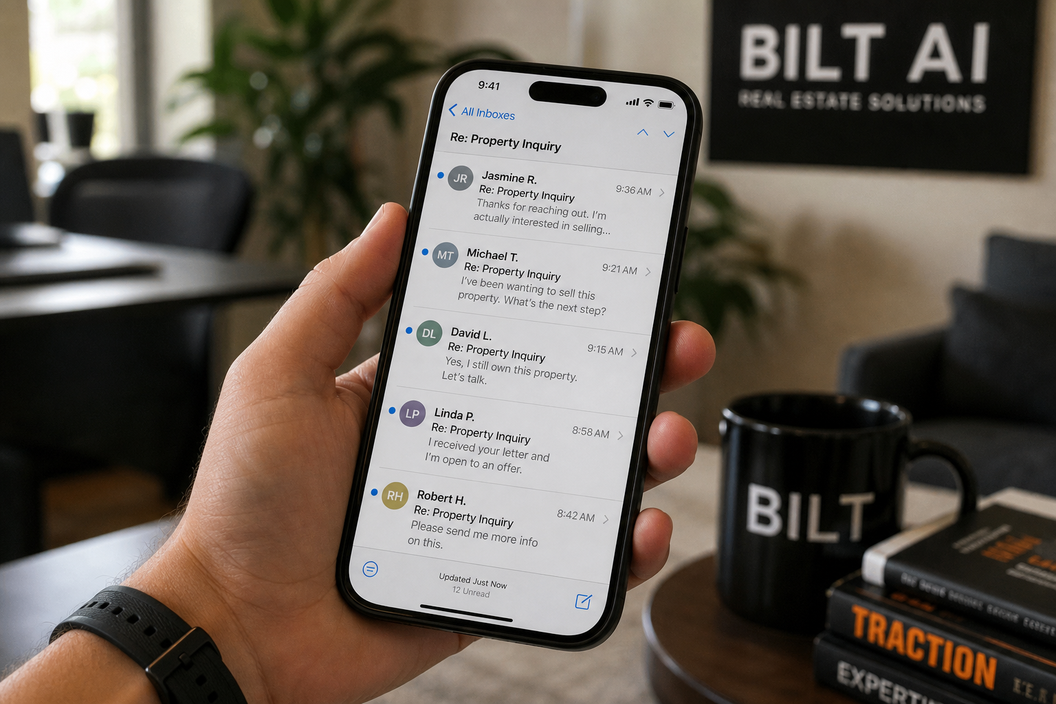 phone screen showing incoming email replies from property owners, hand holding phone, casual office background, natural lighting