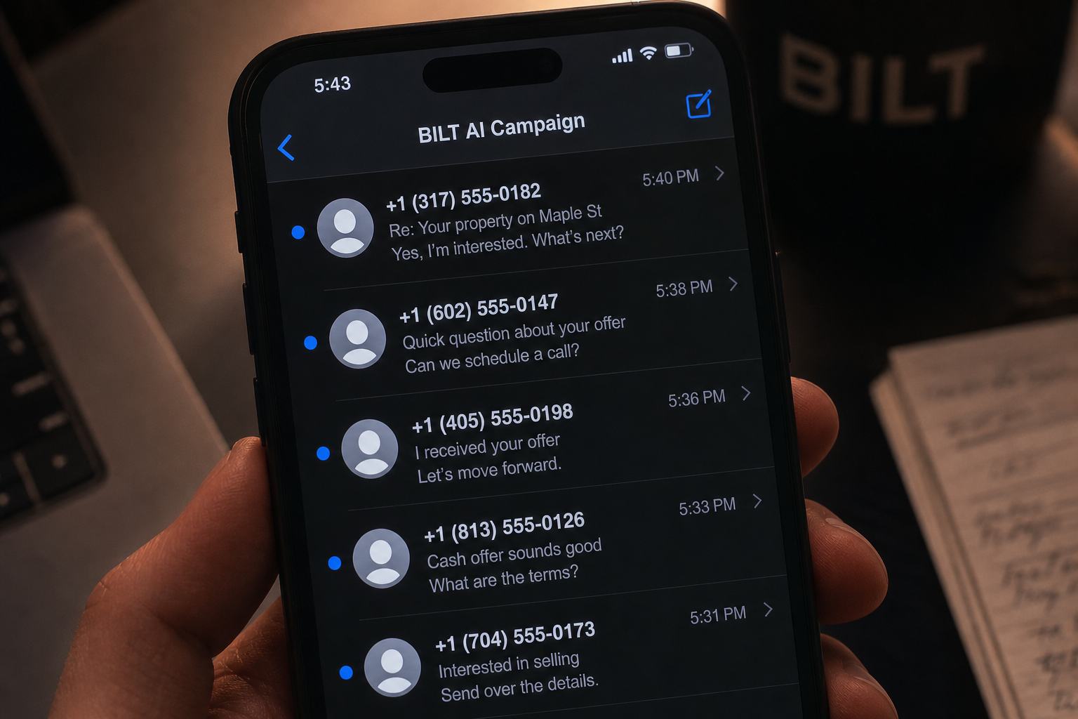 close-up of smartphone showing unread text messages from a real estate investor campaign, slightly dim lighting, focus on screen with blurred background desk