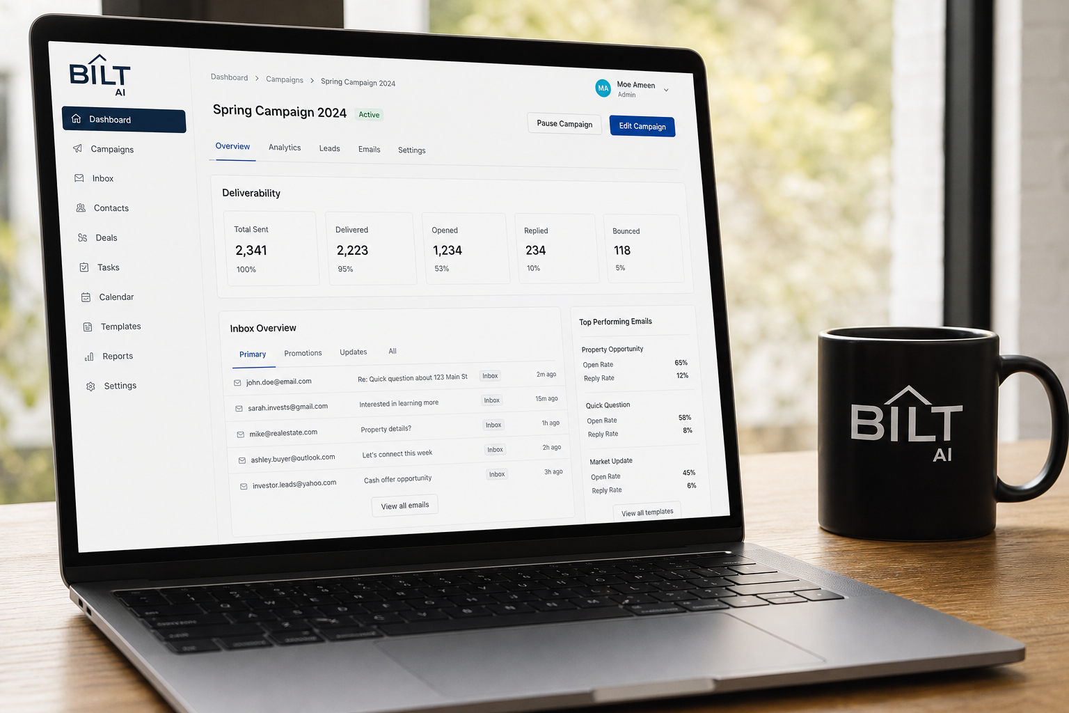 photorealistic laptop screen showing an email campaign dashboard with deliverability metrics, inbox tabs, coffee mug, daylight through window
