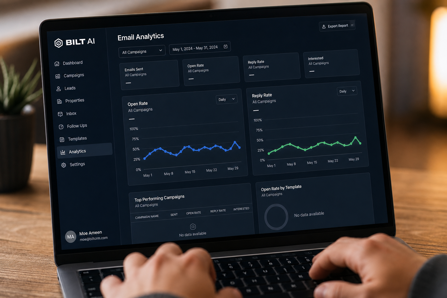 close-up of an email analytics dashboard on a laptop showing open rates and reply metrics, hands on keyboard, soft desk lighting