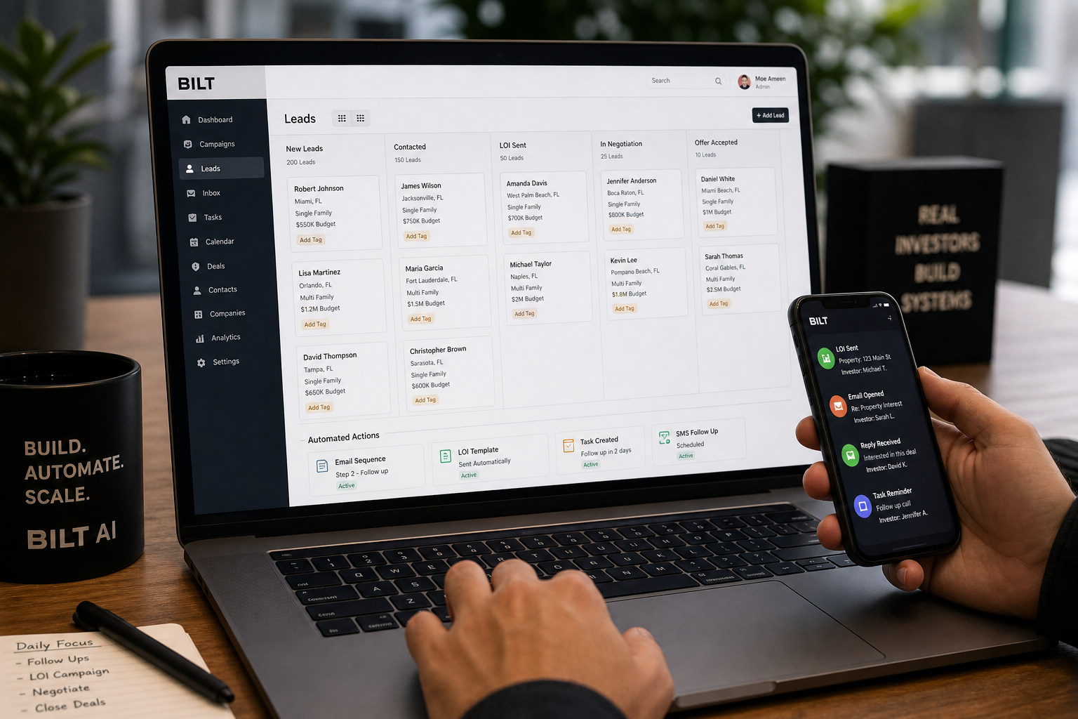 laptop screen showing CRM pipeline with stages and automated actions, investor using phone simultaneously, modern workspace